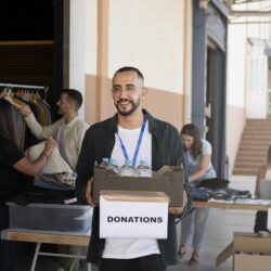 close-up-volunteer-oganizing-stuff-donation